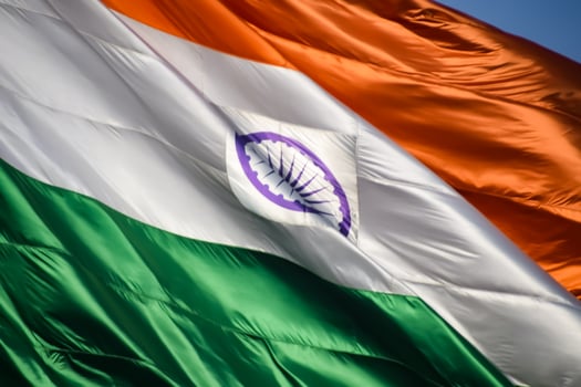 India flag flying high at Connaught Place with pride in blue sky, India flag fluttering, Indian Flag on Independence Day and Republic Day of India, tilt up shot, Waving Indian flag, Har Ghar Tiranga photo