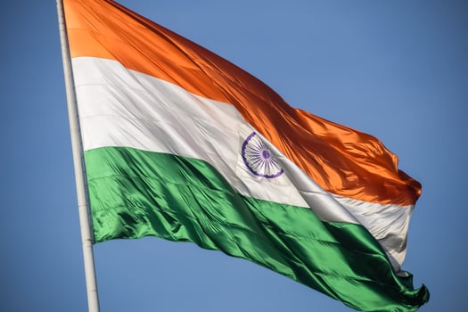 India flag flying high at Connaught Place with pride in blue sky, India flag fluttering, Indian Flag on Independence Day and Republic Day of India, tilt up shot, Waving Indian flag, Har Ghar Tiranga photo