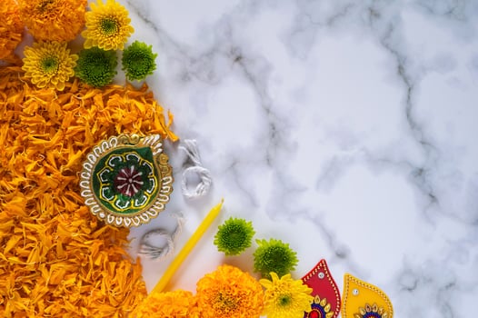 Preparation for Diwali festival decoration with diya clay lamp and flowers on marble floor. photo