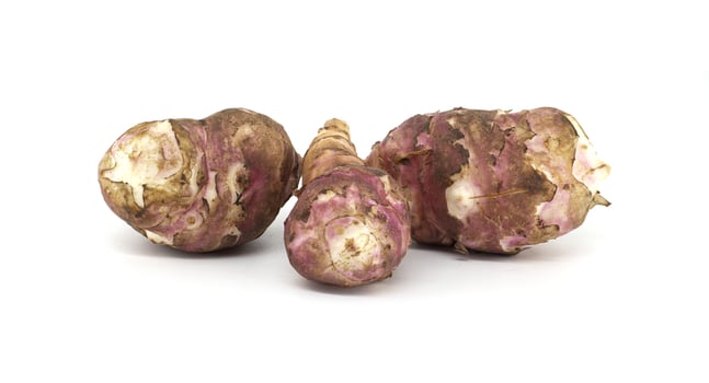 Fresh raw Jerusalem artichokes isolated against a white background photo