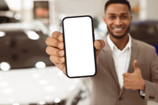Car Sales. Unrecognizable Manager Guy Showing Key Gesturing Thumbs Up Standing Near Auto In Store. Shallow Depth, Copy Space photo
