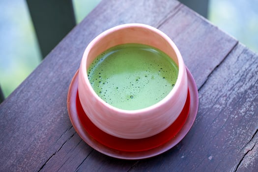 A warm cup of matcha is made of finely ground green tea powder. It's widespread in Japanese culture photo