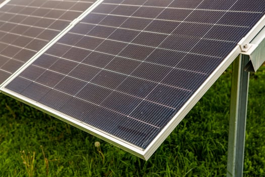 Solar panel on green grass background, Alternative energy from the sun. photo