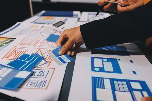 The designer team is designing the uxui system to make the uxui system work well on new phones and support system updates. Website development concept UI UX front end designer photo
