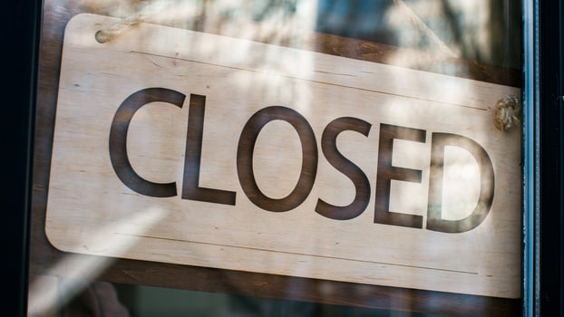 Close-up man waiter salesman turning signboard from closed to open on glass door male restaurant owner seller manager opens cafe shop businessman entrepreneur opening new store small business concept photo