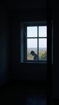 A dimly lit space featuring a large window photo