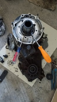 Using Two Screwdrivers to Remove a Snap Ring on a Transfer Case photo
