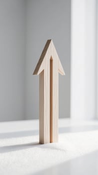 A wooden arrow is standing on a table photo