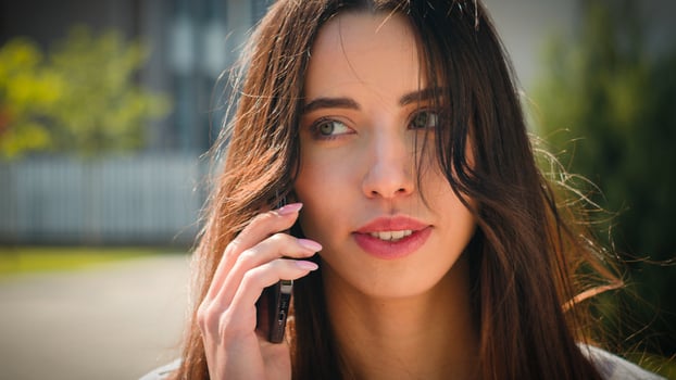 Close-up woman businesswoman student talking on mobile phone outdoors girl client remote make order using smartphone on street speak friend answering business call talk on cellphone female portrait photo