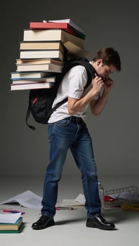 Overwhelmed student struggling under load of overflowing backpack signifying lack of organization photo