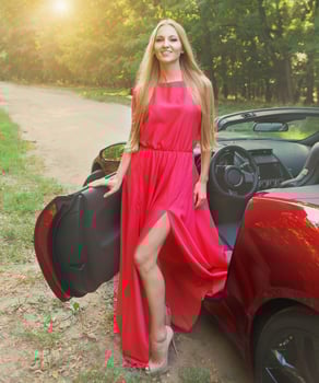 Beautiful blond young woman near a sports car photo