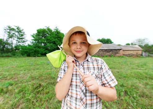 Little boy standing near country house photo