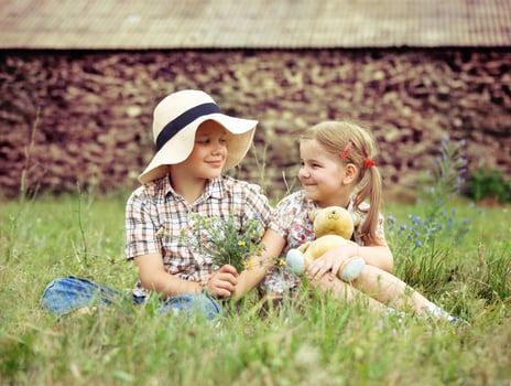 Little boy gives flowers to the cute little girl photo