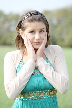 a young woman in a green dress smiling photo