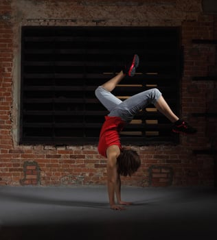 Young smiling blonde girl dancing on hands photo