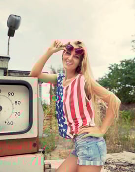 Blond woman on damaged gas station photo