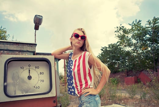 Blond girl on damaged gas station photo