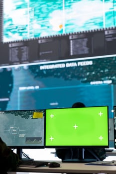 Intelligence analyst reviews air and sea activity next to an isolated mockup display, following gps coordinates of vessels anchoring in the ports. Army trooper working in monitoring room. photo