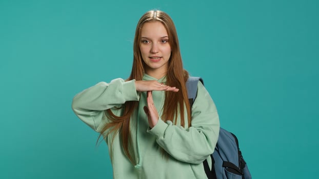 Portrait of assertive woman asking for timeout, doing hand gestures, feeling fatigued. Unhappy girl doing vehement pause sign gesturing, wishing for break, studio background, camera A photo