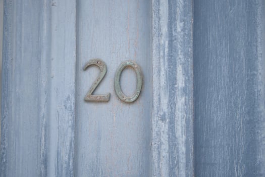 A weathered, rustic wooden door showcasing the number 20 in a charming and decorative style photo