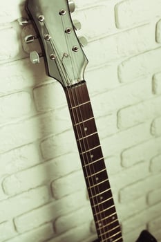 Electric guitar body and neck detail on wooden background photo