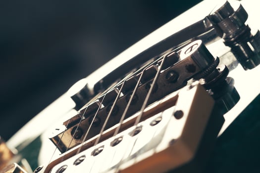 Electric guitar body and neck detail on wooden background photo