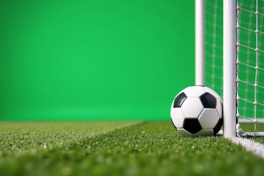 Soccer Ball Near Goalpost on Green Field photo