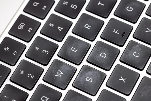 keyboard of famous silver colored laptop with fingerprints photo