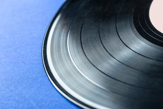 Retro vinyl record on blue background photo