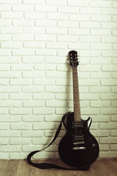 Electric guitar body and neck detail on wooden background photo