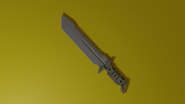 A knife on a yellow background with a black handle photo