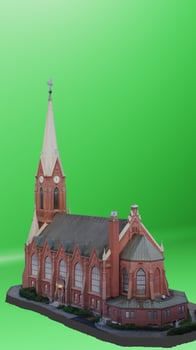 A model of a church on a green background photo