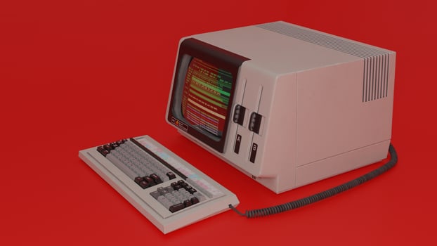 An old computer with a keyboard and mouse on a red background photo