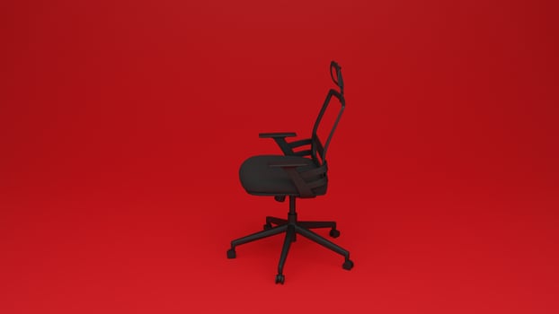 A black office chair on a red background photo