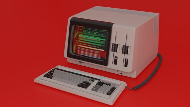 An old computer with a keyboard and monitor on a red background photo
