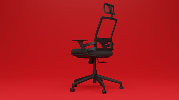 A black office chair against a red background photo