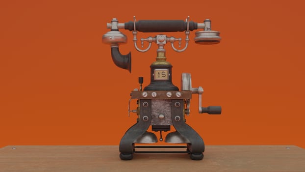 A vintage telephone on a table with an orange background photo