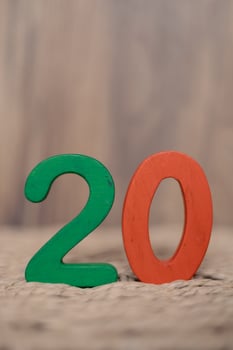Close-up wooden figure number twenty on a beige blurred background photo