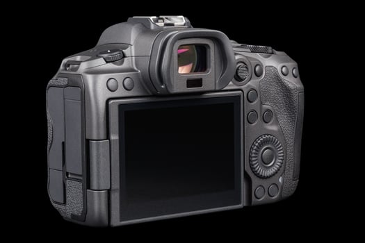 black professional mirrorless camera body isolated on black background photo