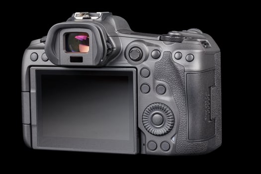 black professional mirrorless camera body isolated on black background photo