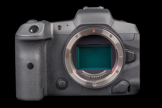 black professional mirrorless camera body isolated on black background photo