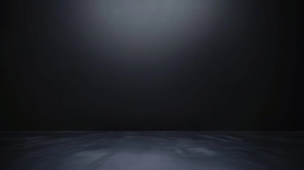 Dark room with black floor and light coming from the ceiling photo