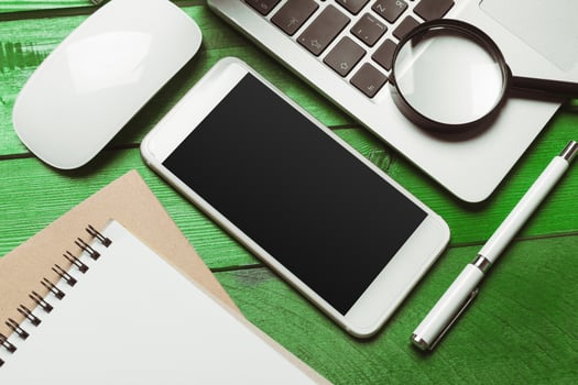 Office table with smartphone on it. View from above photo