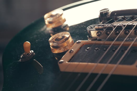 Electric guitar body and neck detail on wooden background photo