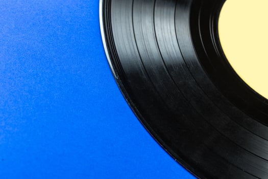 Retro vinyl record on blue background photo