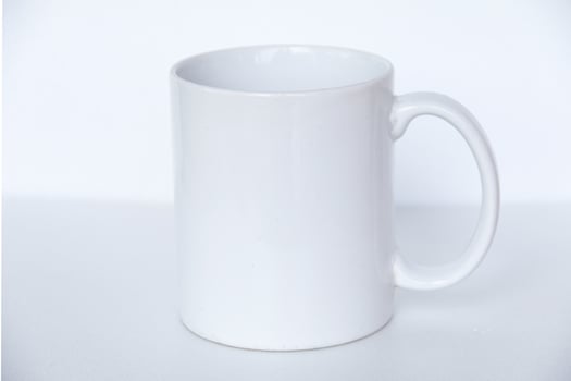 Elegant white ceramic mug isolated on a blank background, suitable for product marketing, mockups, and graphic design photo
