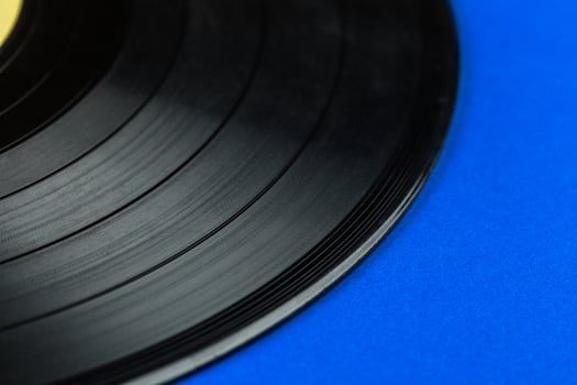 Retro vinyl record on blue background photo