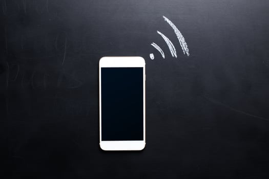 Wireless Symbol Drawn on a Blackboard near smartphone photo