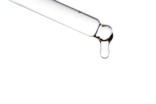 Dropper pipette with delicious serum with bubbles close-up. photo