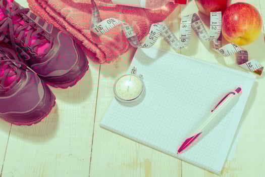 Shoes and sports equipment on wooden floor, top view photo
